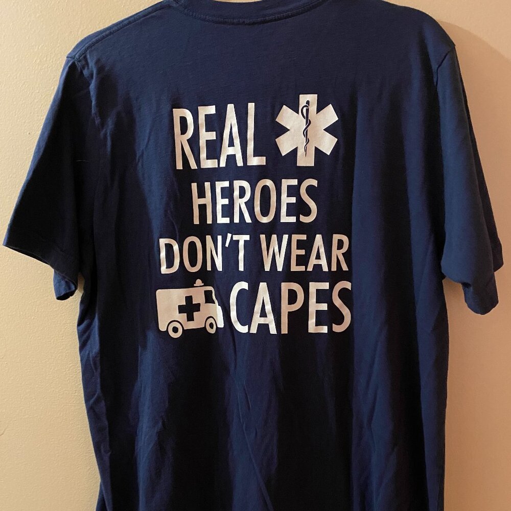 TEE SHIRT BLUE "REAL HEROES DON'T WEAR CAPES" GENTLY WORN FOR PHOTOS